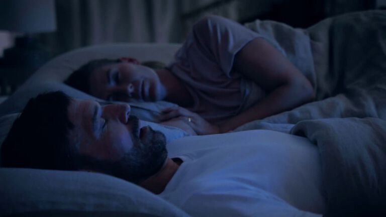 Couple sleeping, man snoring on TEMPUR mattress